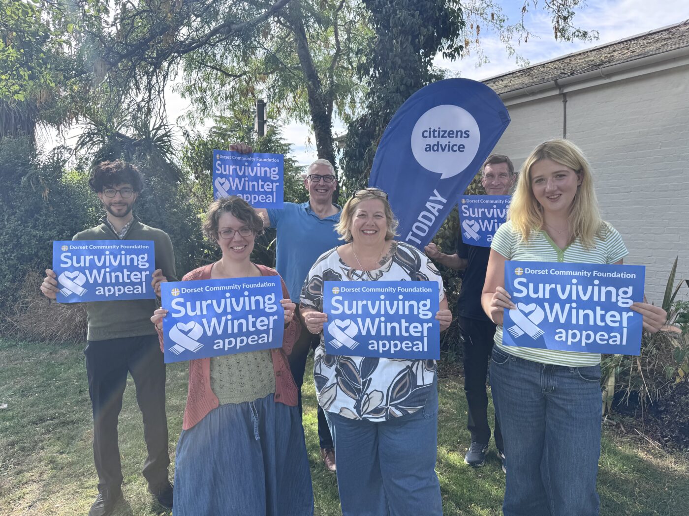 A picture of members of members of the Citizens Advice energy team holding Surviving Winter appeal posters