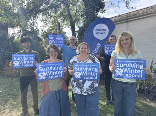 A picture of members of members of the Citizens Advice energy team holding Surviving Winter appeal posters